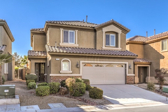 mediterranean / spanish-style home with a garage