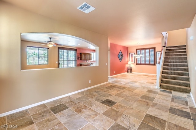 interior space with ceiling fan