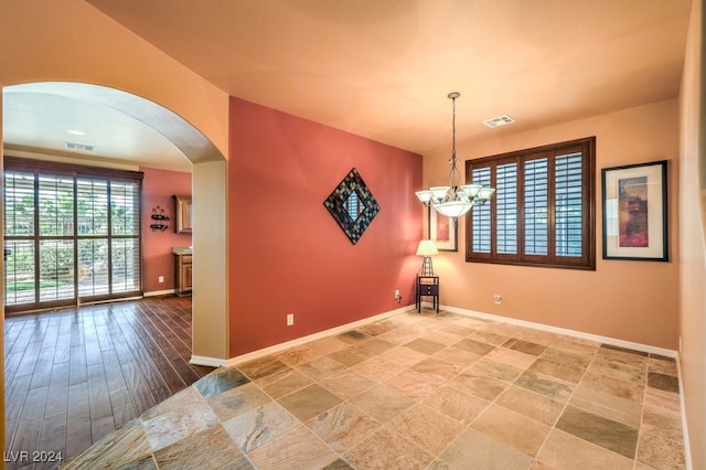 empty room with a notable chandelier