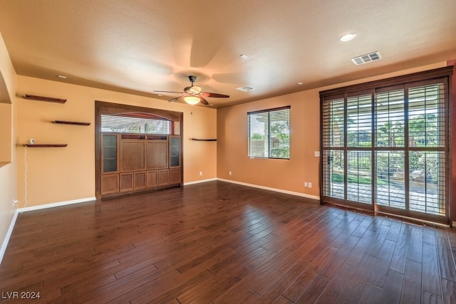 unfurnished living room with ceiling fan and dark hardwood / wood-style floors