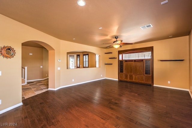 unfurnished living room with ceiling fan and dark hardwood / wood-style floors