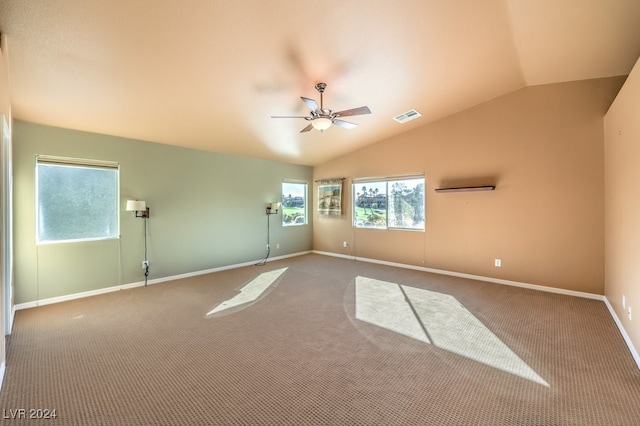 empty room featuring carpet floors, vaulted ceiling, and ceiling fan