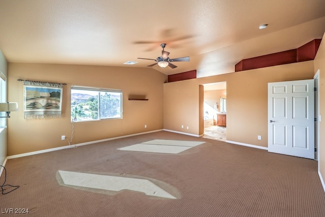 carpeted empty room with ceiling fan and vaulted ceiling