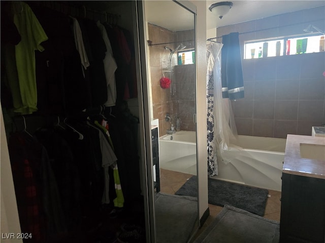 bathroom featuring vanity, tile patterned floors, and shower / bath combo with shower curtain