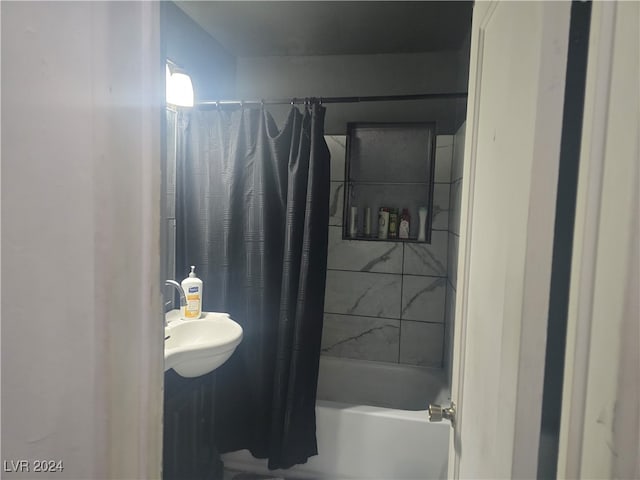 bathroom featuring sink and shower / tub combo with curtain