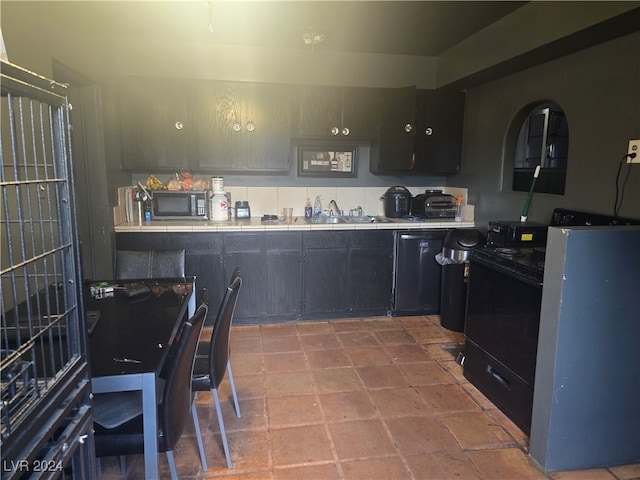 kitchen with backsplash, sink, and black dishwasher