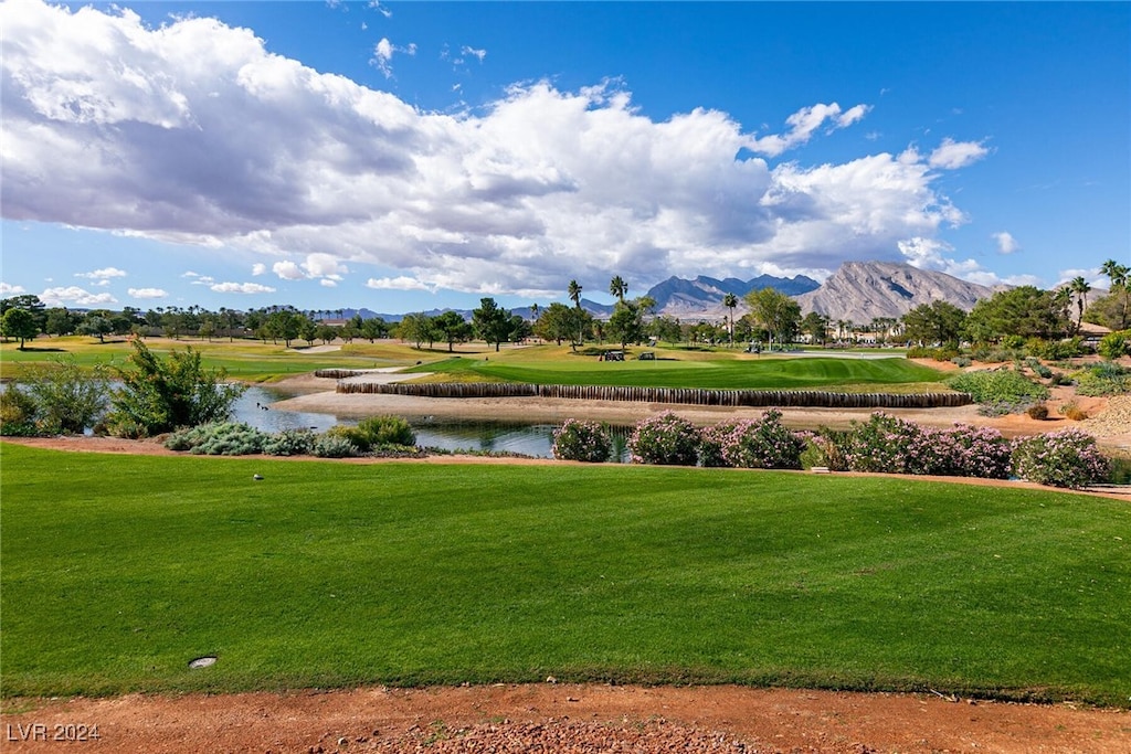 view of home's community featuring a water and mountain view and a lawn