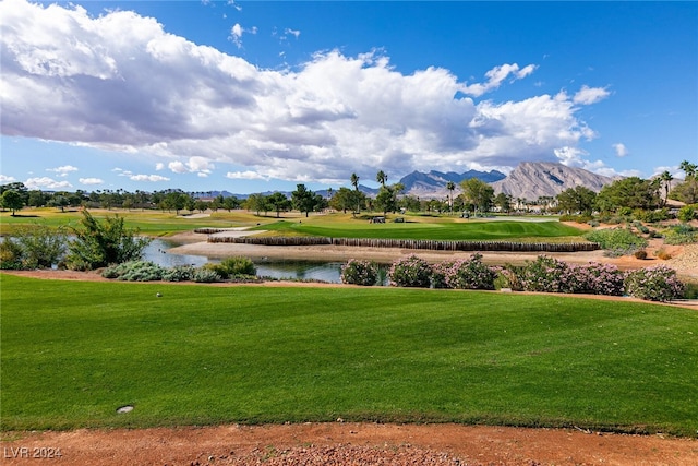 view of home's community featuring a water and mountain view and a lawn