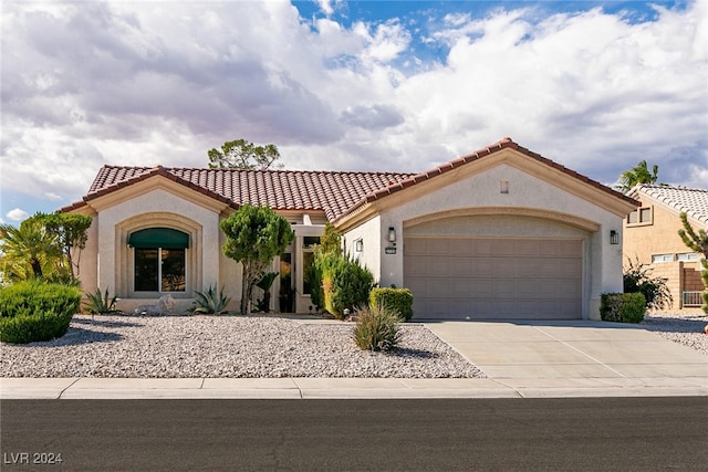 mediterranean / spanish-style house with a garage