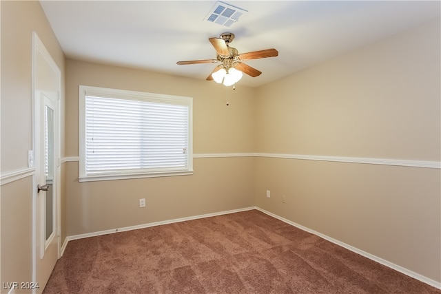 carpeted spare room with ceiling fan