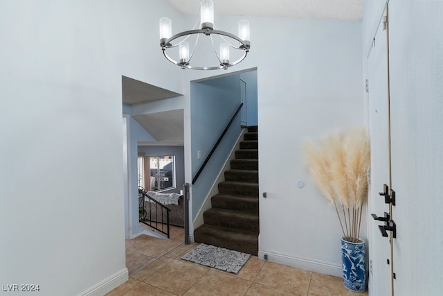 tiled entrance foyer featuring a chandelier