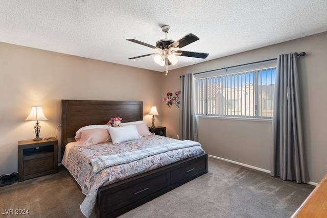 bedroom with dark colored carpet, a textured ceiling, and ceiling fan