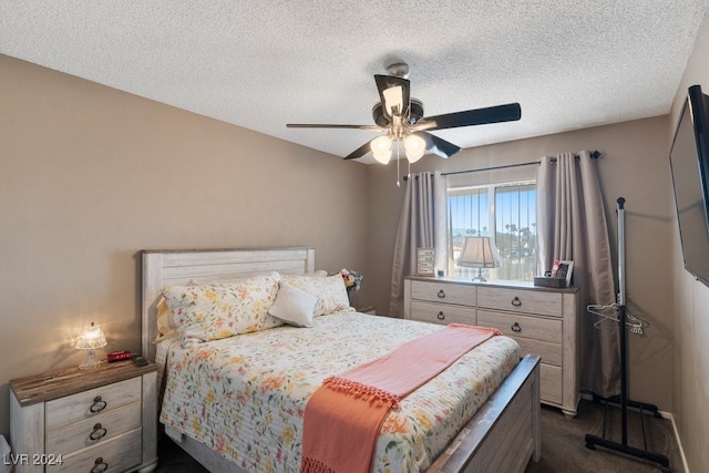 carpeted bedroom featuring ceiling fan and a textured ceiling