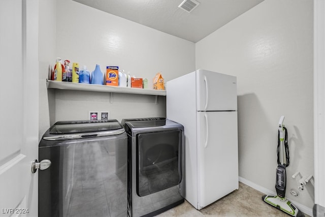 laundry room with independent washer and dryer