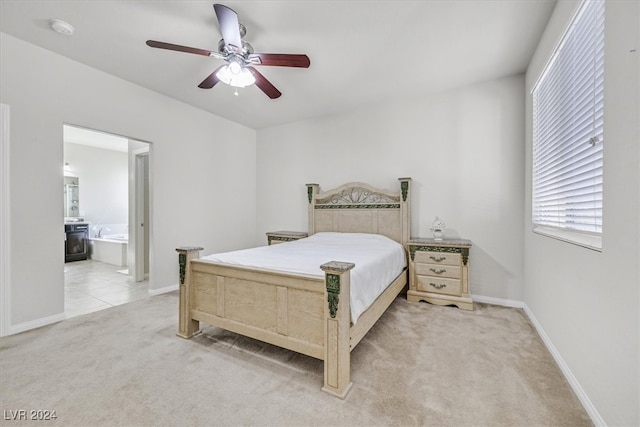 carpeted bedroom featuring ceiling fan and ensuite bathroom