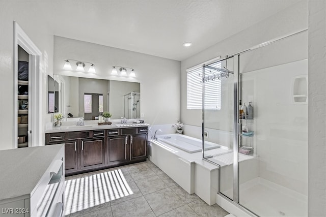 bathroom with tile patterned floors, vanity, separate shower and tub, and a chandelier