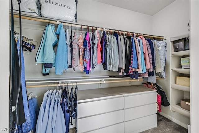 spacious closet with dark carpet