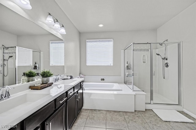 bathroom featuring tile patterned flooring, vanity, and shower with separate bathtub