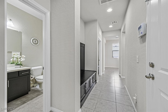 hall featuring light tile patterned floors