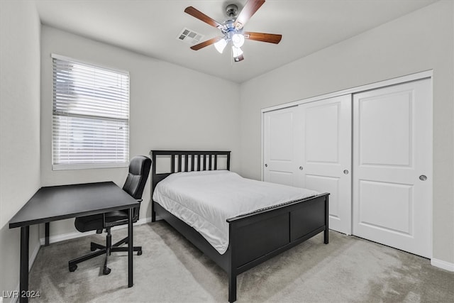 carpeted bedroom with ceiling fan and a closet