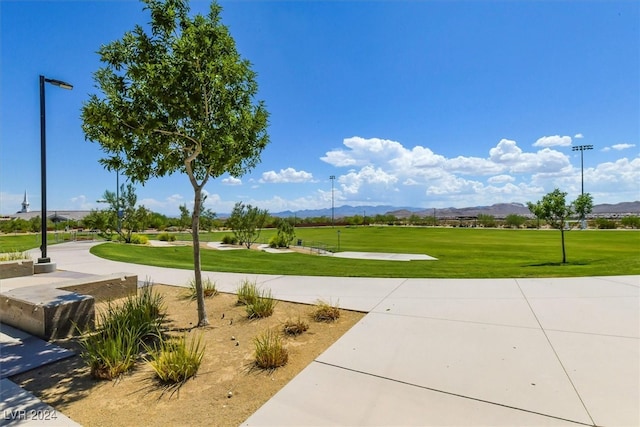 view of home's community featuring a lawn and a mountain view