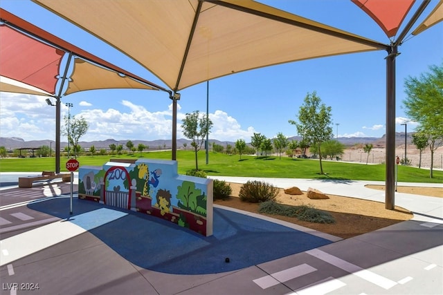 view of home's community with a mountain view and a lawn