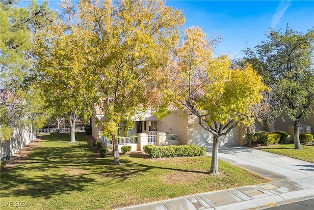 obstructed view of property with a garage and a front lawn