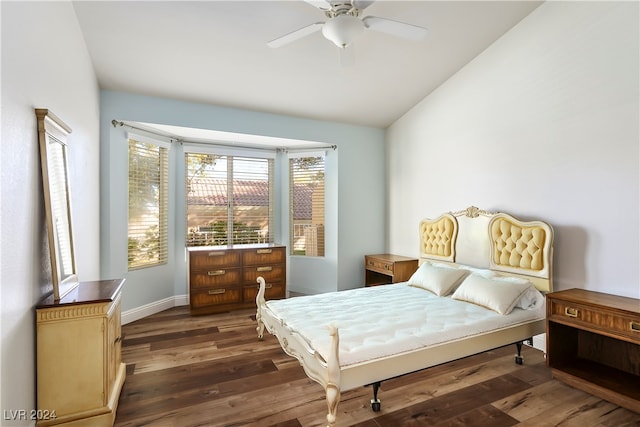 bedroom with ceiling fan, dark hardwood / wood-style flooring, and lofted ceiling