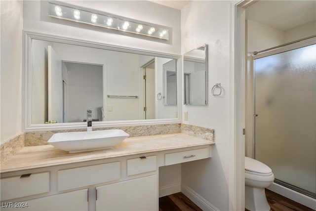 bathroom featuring hardwood / wood-style flooring, vanity, an enclosed shower, and baseboard heating