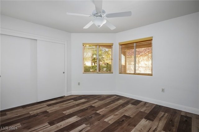 unfurnished bedroom featuring dark hardwood / wood-style floors, ceiling fan, and a closet