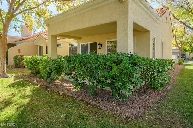 view of side of home featuring a lawn