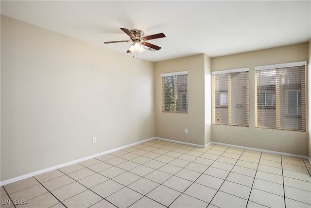 spare room featuring light tile patterned floors and ceiling fan