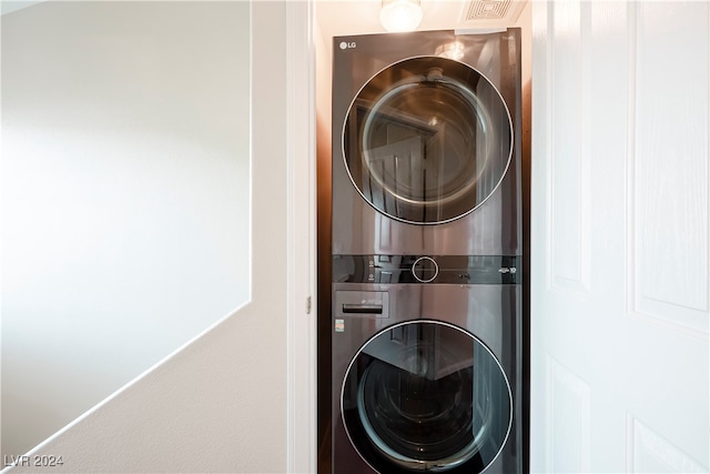 laundry room featuring stacked washing maching and dryer