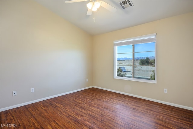 unfurnished room with ceiling fan and dark wood-type flooring