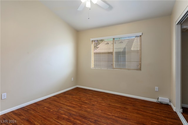 spare room with ceiling fan and dark hardwood / wood-style flooring