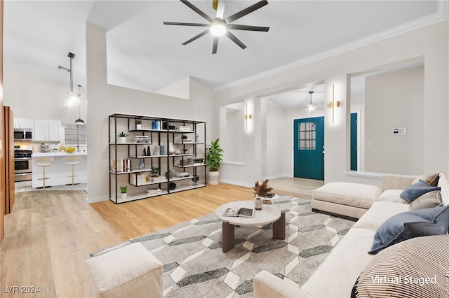 living room featuring light wood-type flooring, ceiling fan, and ornamental molding