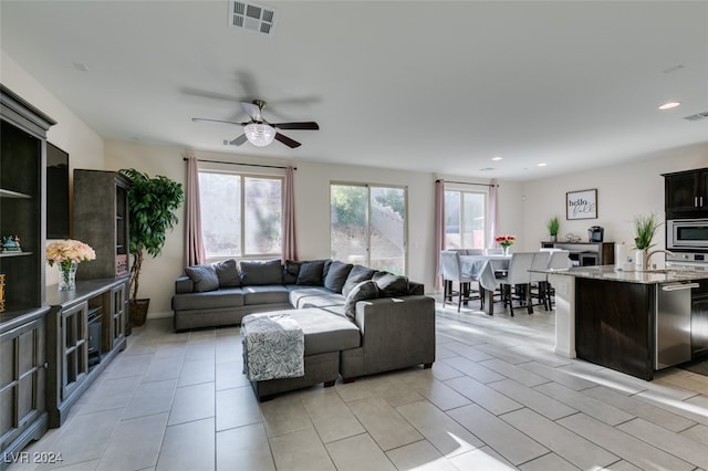 tiled living room featuring ceiling fan