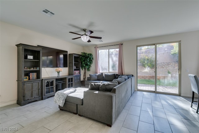 tiled living room featuring ceiling fan