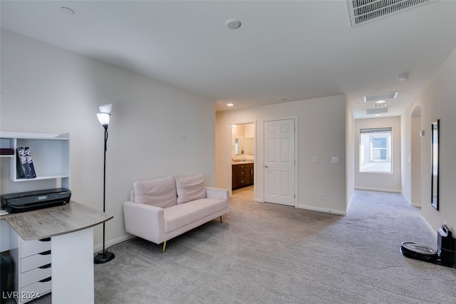 sitting room featuring light carpet