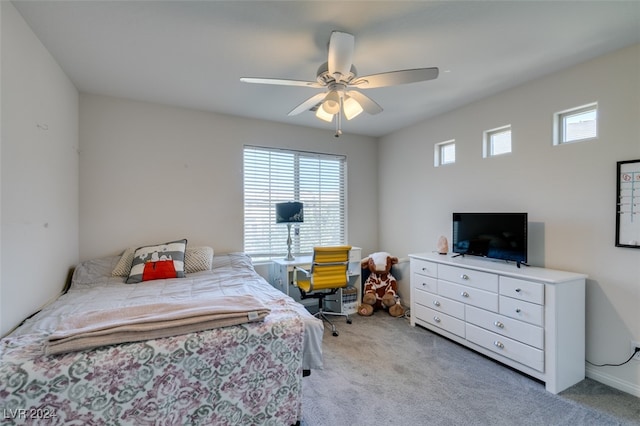 carpeted bedroom with ceiling fan and multiple windows