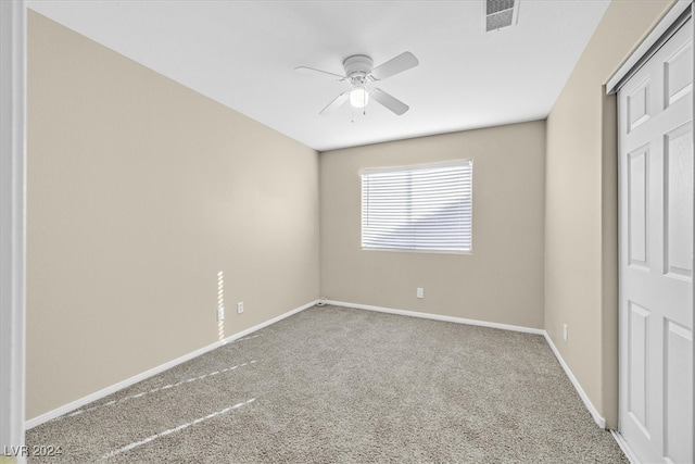 unfurnished bedroom featuring ceiling fan, carpet floors, and a closet