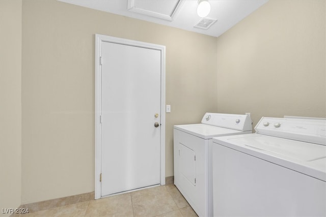 clothes washing area featuring independent washer and dryer and light tile patterned floors