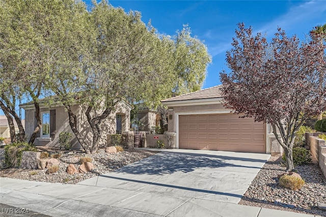 view of property hidden behind natural elements featuring a garage