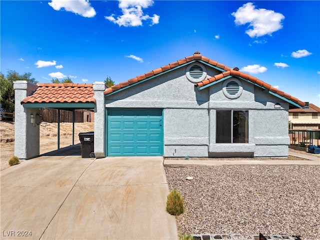 view of front of house with a garage and a carport