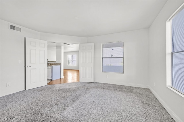 unfurnished living room featuring carpet floors