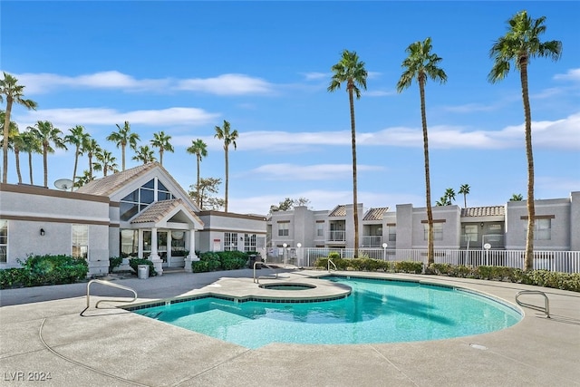 view of swimming pool with a community hot tub