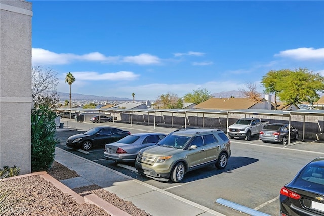 view of parking / parking lot featuring a carport