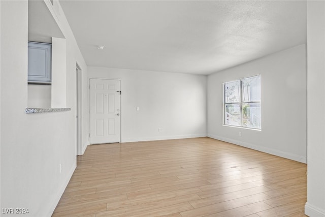 spare room featuring light hardwood / wood-style floors