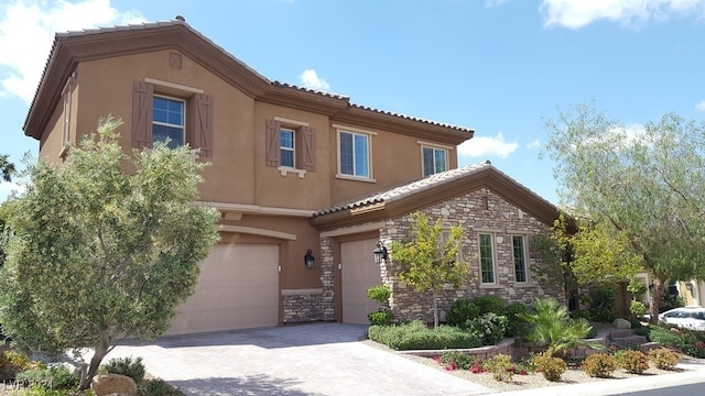 mediterranean / spanish home featuring a garage