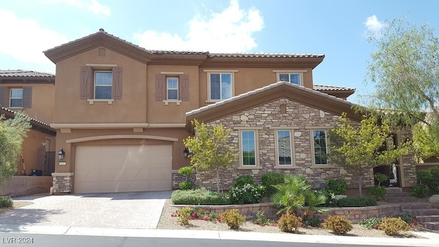 mediterranean / spanish-style house with a garage